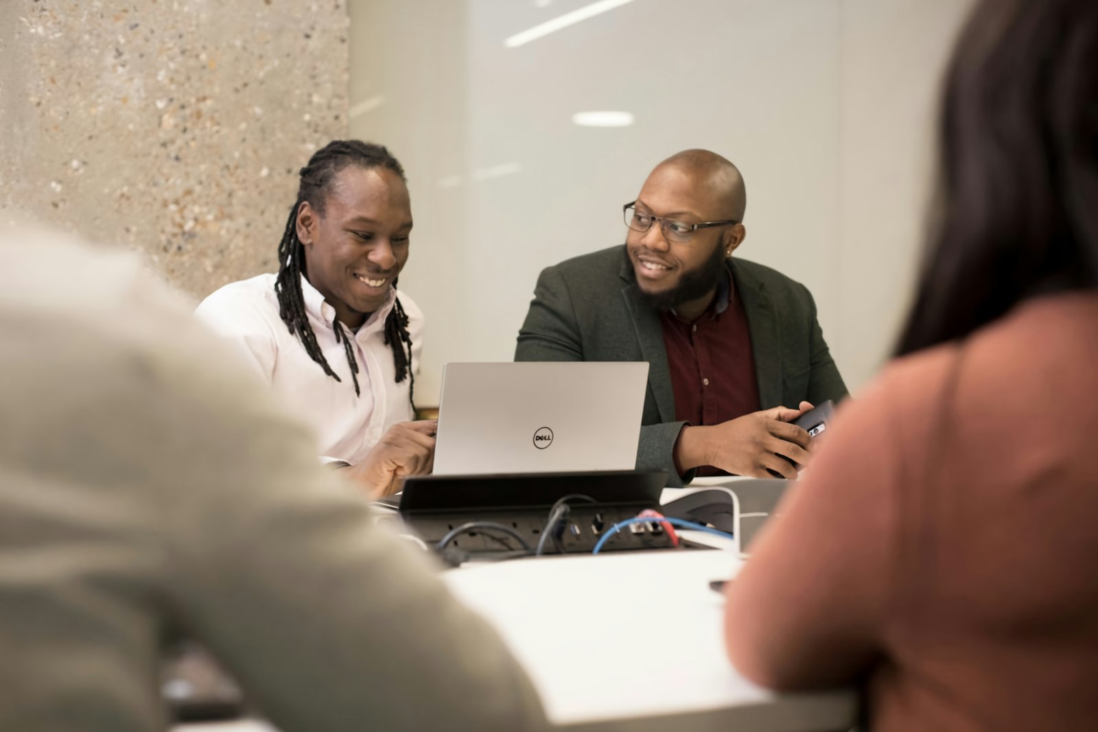 Employees using a laptop together at work