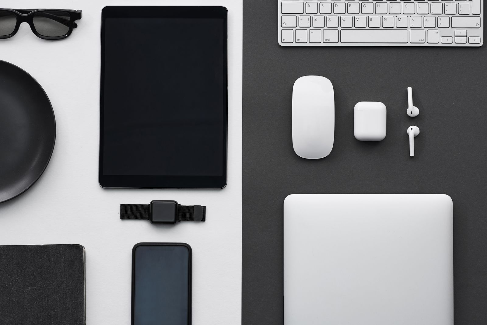 A laptop, tablet and smartphones on a desk